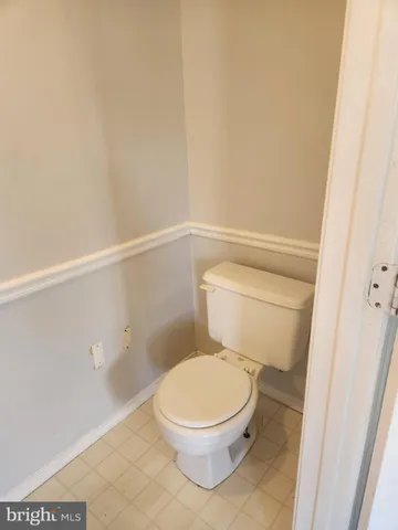 a white toilet sitting next to a shower