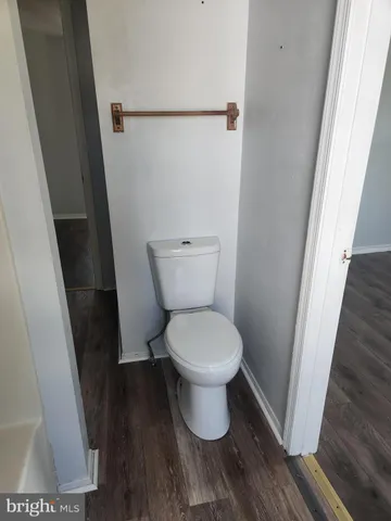 a white toilet sitting next to a sink