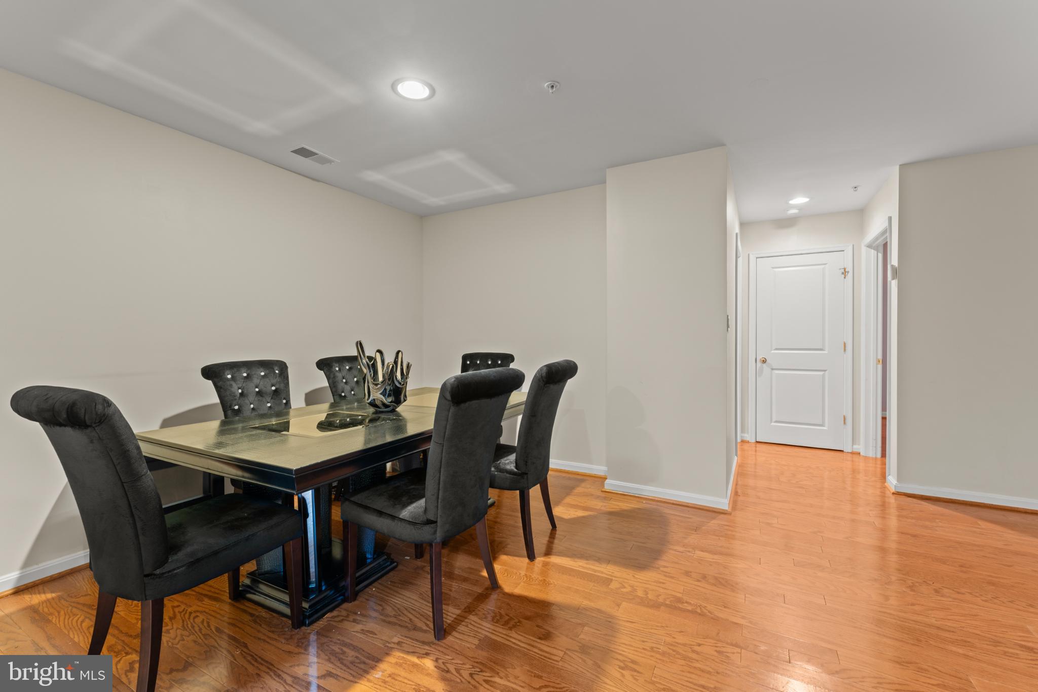 9510 Coyle Road, Unit 201 Owings Mills, MD 21117 - Photo 21 of 34 Elegant dining space with warm wood floors