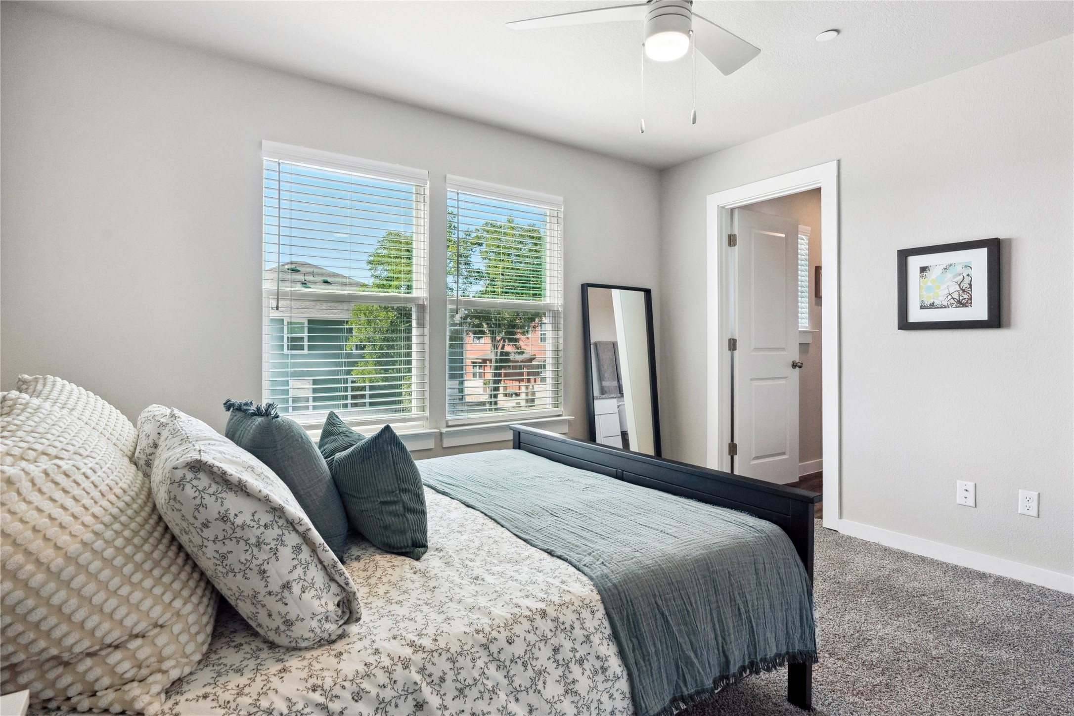 520 Powell Drive Leander, TX 78641 - Photo 25 of 32 a bedroom with a large bed and a chandelier