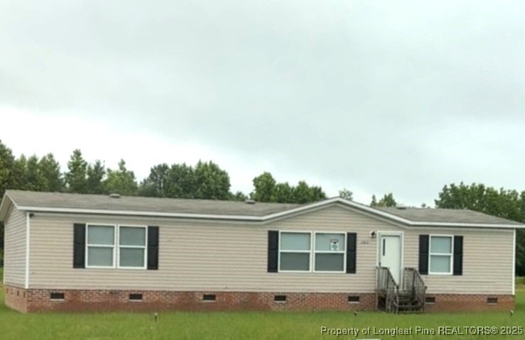 a front view of a house with a garden and yard