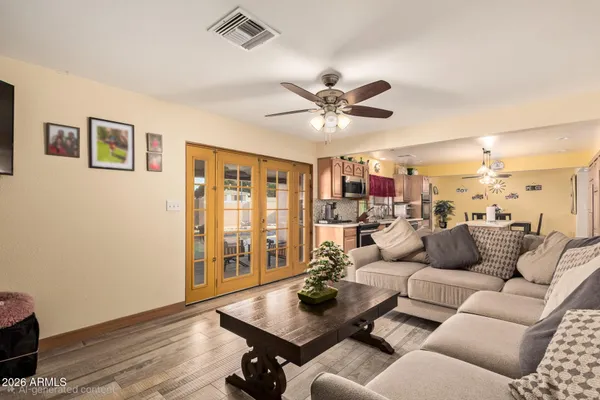 a living room with furniture and wooden floor