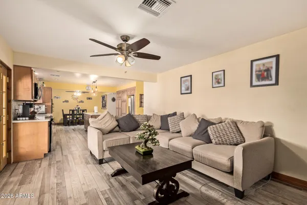 a living room with furniture and a wooden floor