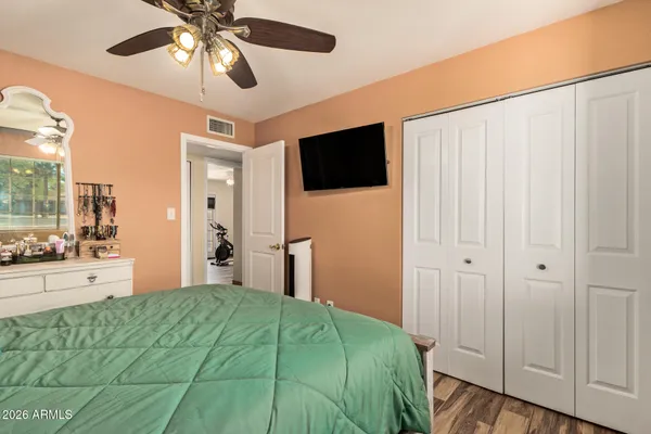 a bedroom with a bed and a chandelier
