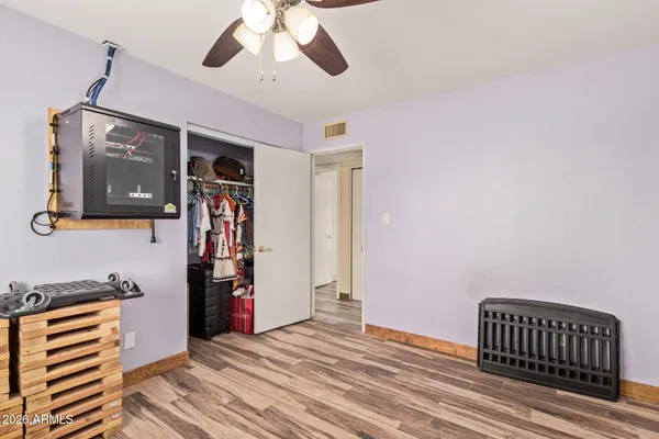 a view of empty room with wooden floor