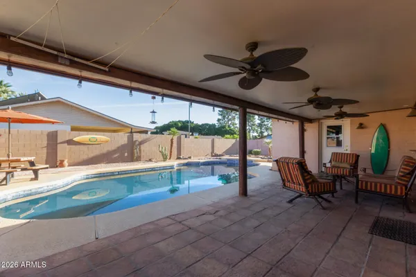 a view of a porch with furniture and a yard