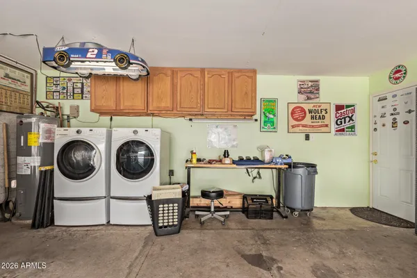 a view of a kitchen with fridge and wooden floor