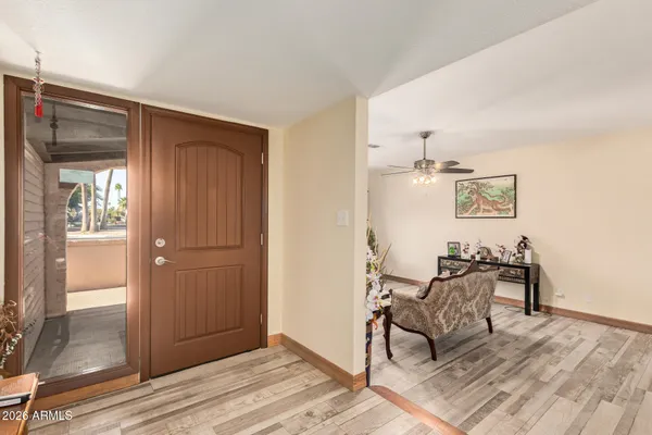 a view of a room with wooden floor wooden cabinet and windows