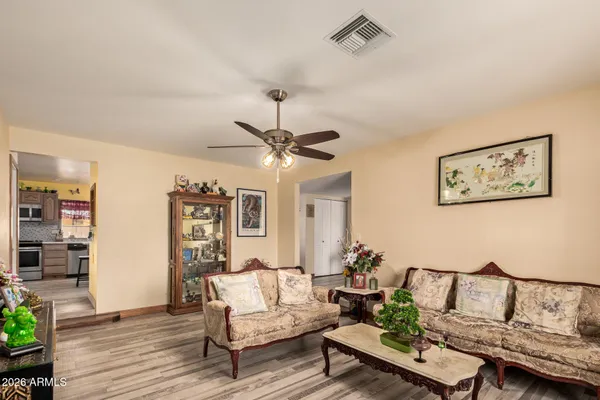 a living room with furniture and wooden floor