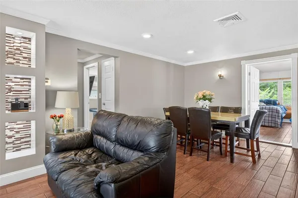 a living room with furniture and wooden floor