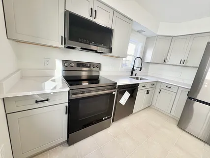 a kitchen with a stove microwave and sink