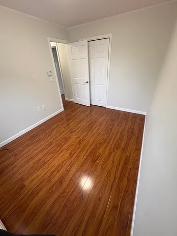 an empty room with wooden floor
