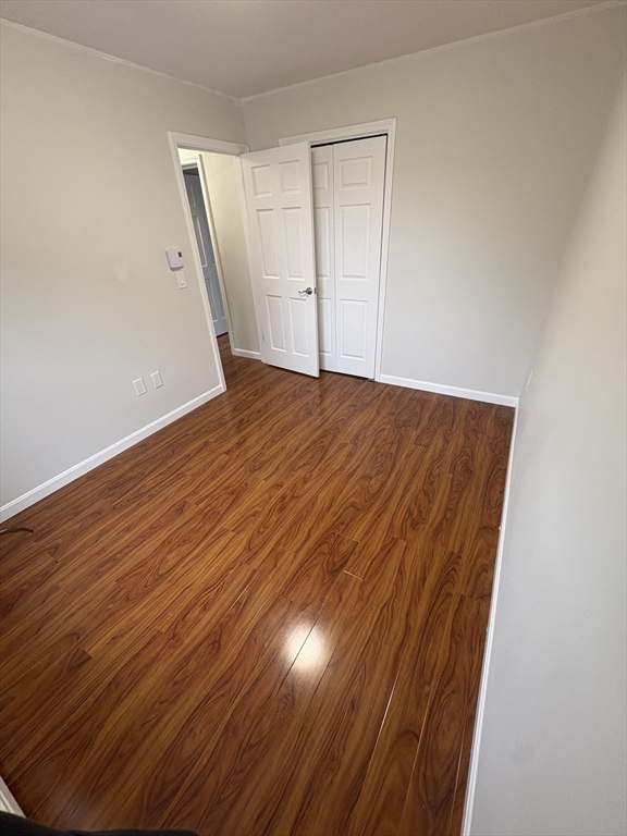 33 Home Street, Unit A Beverly, MA 01915 - Photo 12 of 12 an empty room with wooden floor