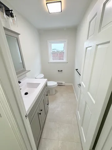 a bathroom with a sink a mirror and a toilet
