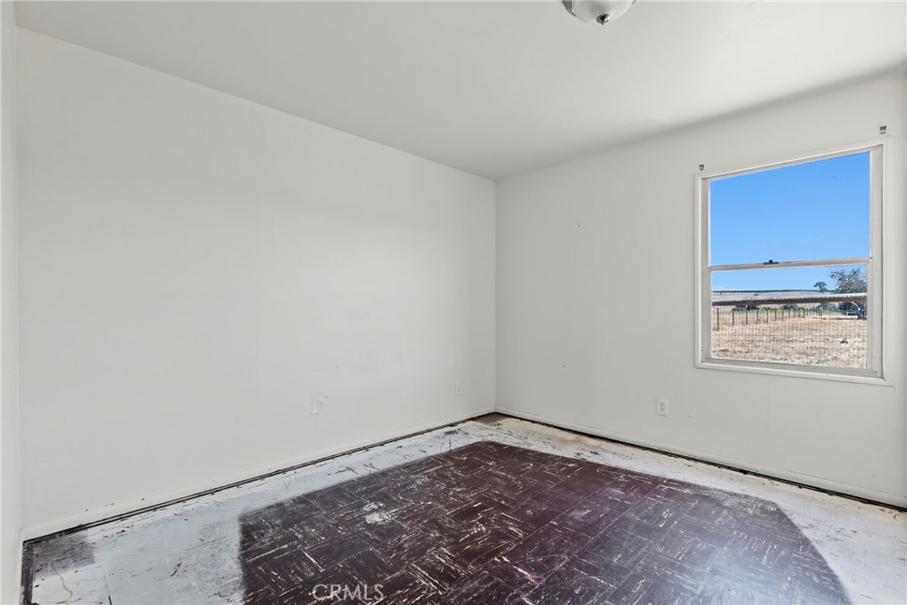 117 West El Campo Road Arroyo Grande, CA 93420 - Photo 12 of 43 a view of a room with wooden floor and windows