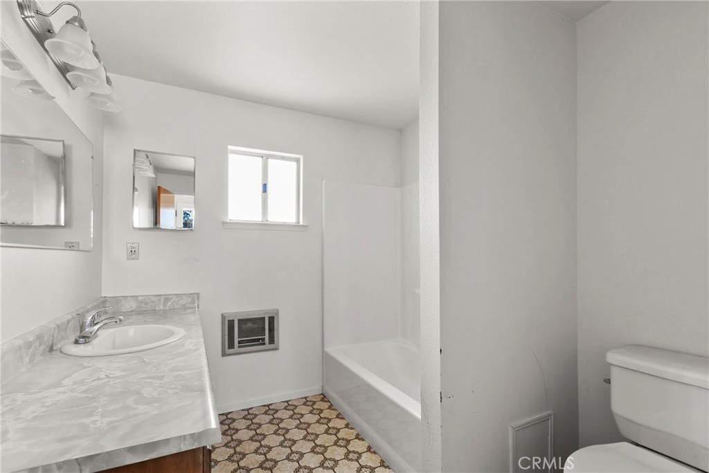 117 West El Campo Road Arroyo Grande, CA 93420 - Photo 18 of 43 a bathroom with a granite countertop sink a toilet and shower