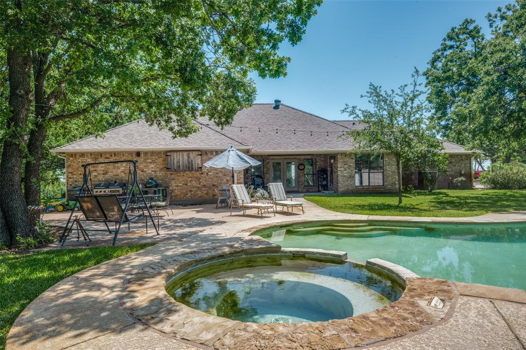 778 County Road 3141 Decatur, TX 76234 - Photo 23 of 25 a view of a house with swimming pool and sitting area