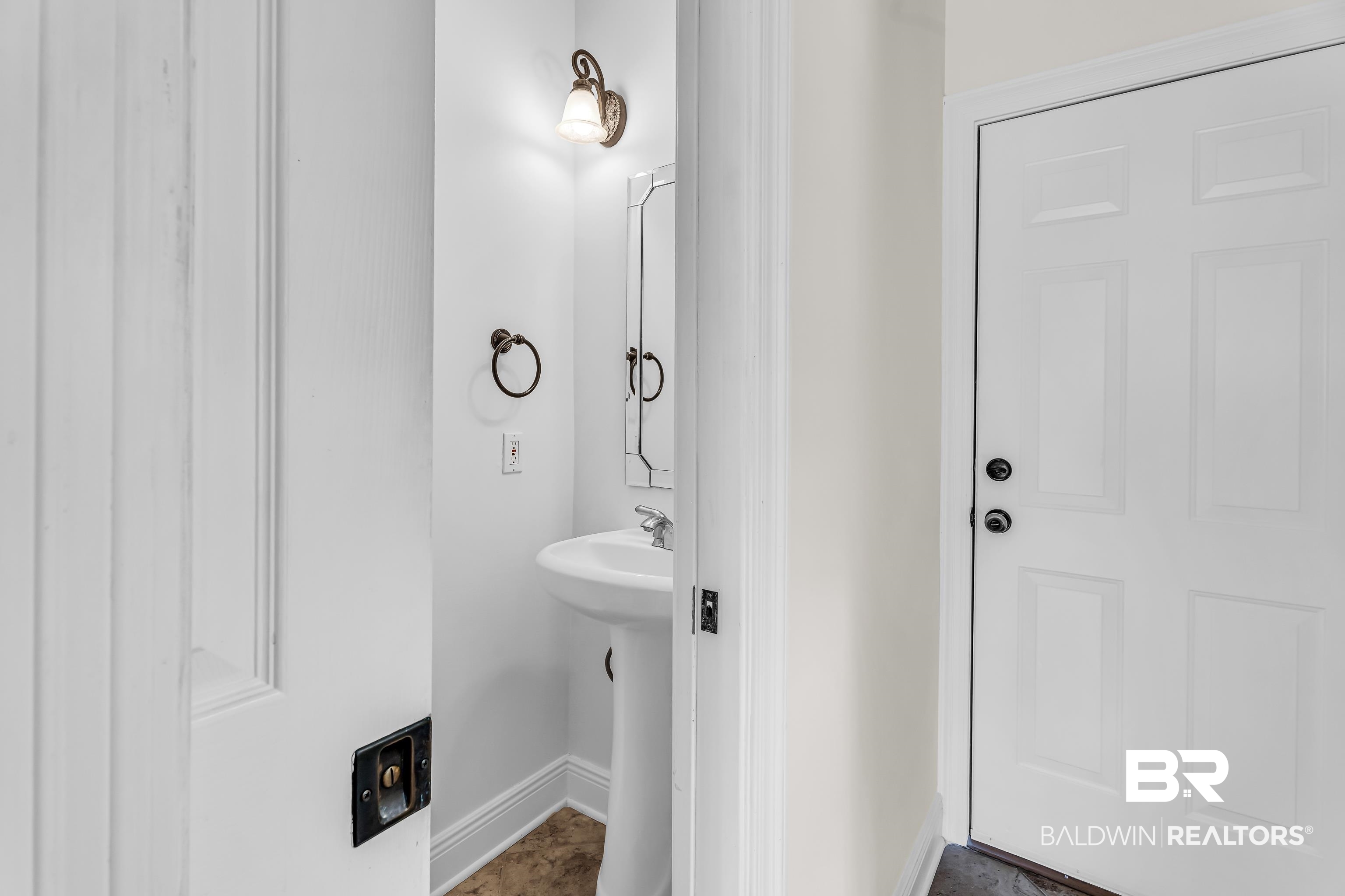 7495 Bromley Road Bay Minette, AL 36507 - Photo 20 of 31 Pocketed door on half bath across from laundry