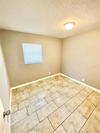 a kitchen with a white stove top oven and white cabinets