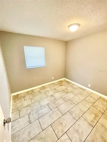 a kitchen with a white stove top oven and white cabinets