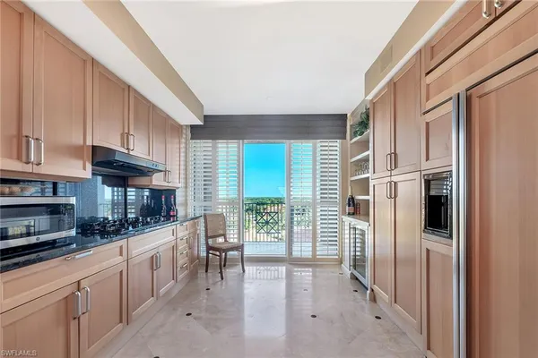 a kitchen with stainless steel appliances a refrigerator and a stove