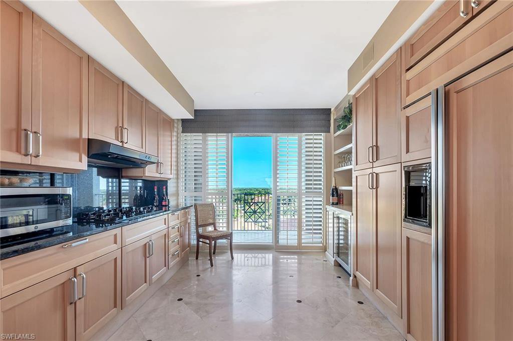 6597 Nicholas Boulevard, Unit 1002 Naples, FL 34108 - Photo 15 of 41 a kitchen with stainless steel appliances a refrigerator and a stove