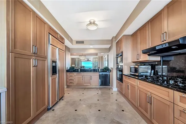 a kitchen with stainless steel appliances a refrigerator and a stove