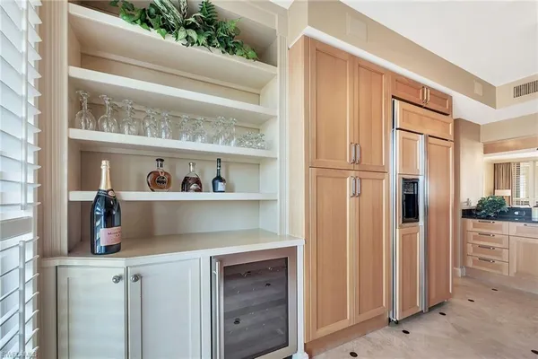a kitchen with a refrigerator and cabinets