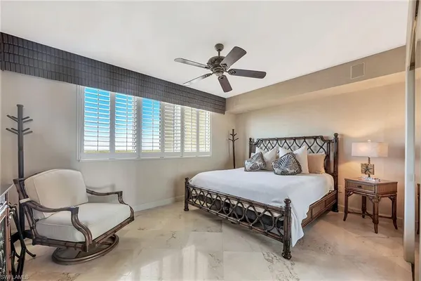 a bedroom with a bed chair and window