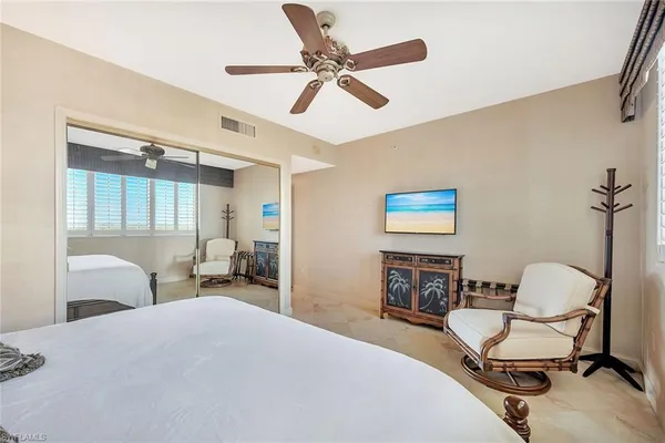 a bedroom with a bed and a chair