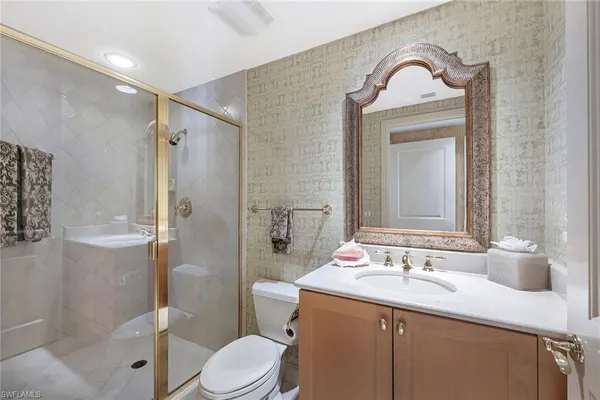 a bathroom with a sink toilet and shower