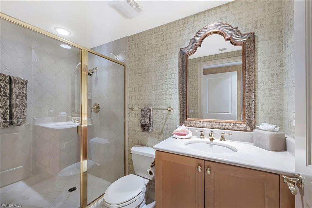 6597 Nicholas Boulevard, Unit 1002 Naples, FL 34108 - Photo 27 of 41 a bathroom with a sink toilet and shower