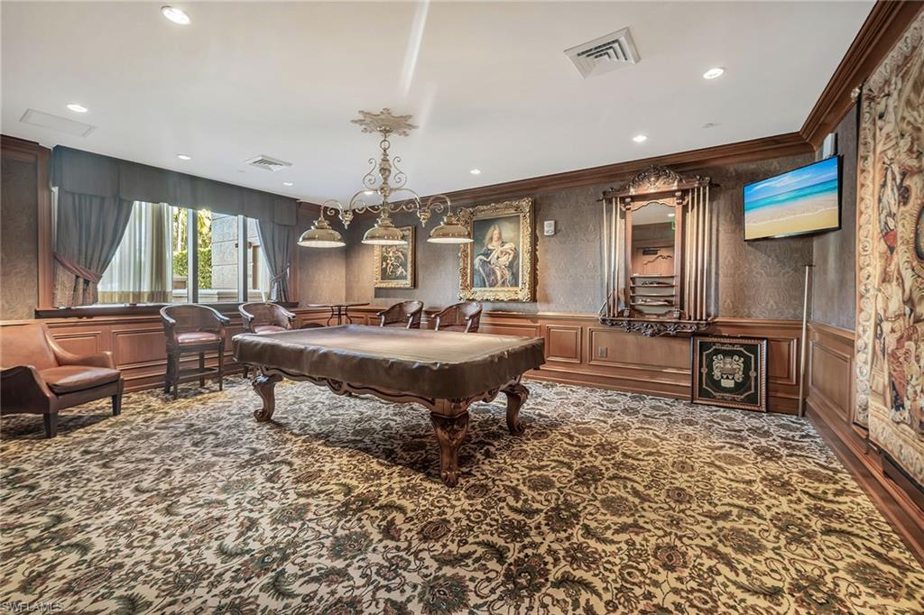 6597 Nicholas Boulevard, Unit 1002 Naples, FL 34108 - Photo 30 of 41 a living room with a couch and a table
