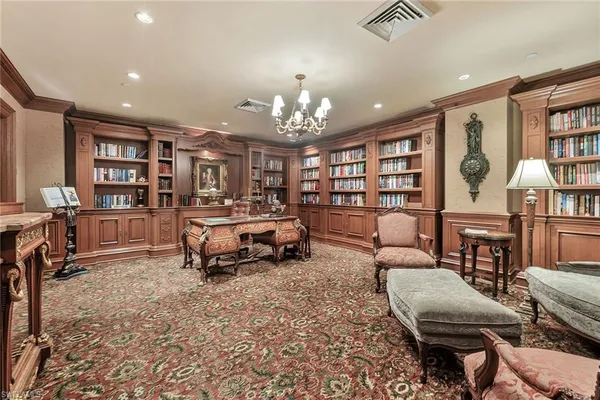 a living room with furniture a bookshelf and a book shelf