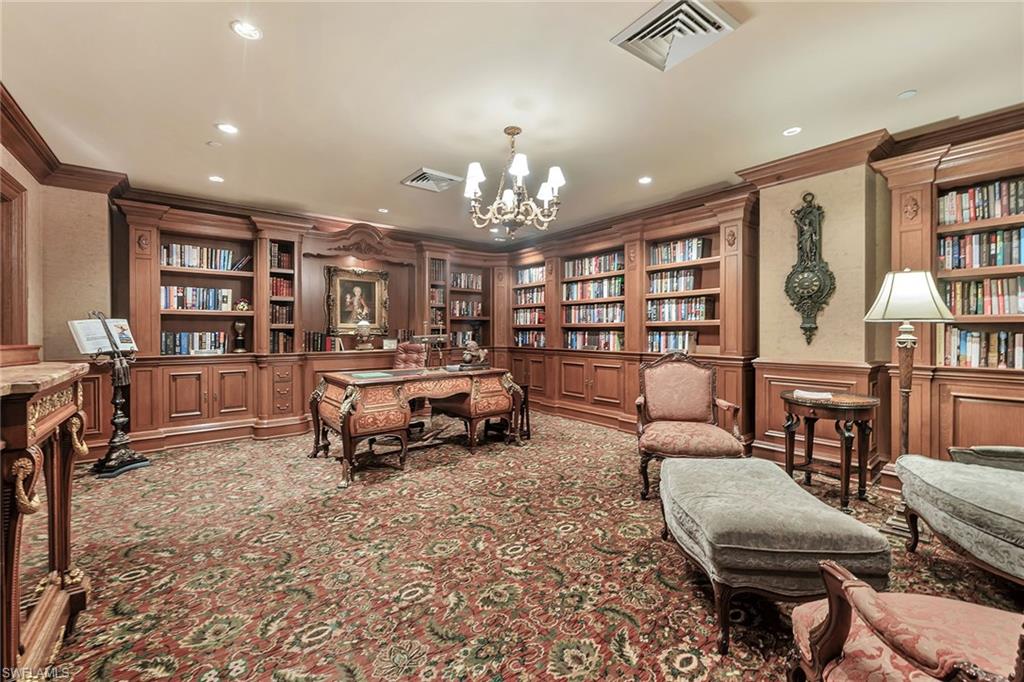 6597 Nicholas Boulevard, Unit 1002 Naples, FL 34108 - Photo 31 of 41 a living room with furniture a bookshelf and a book shelf