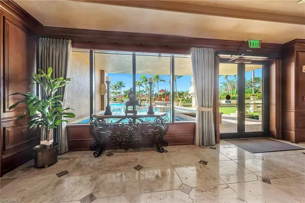 a room with furniture and large windows