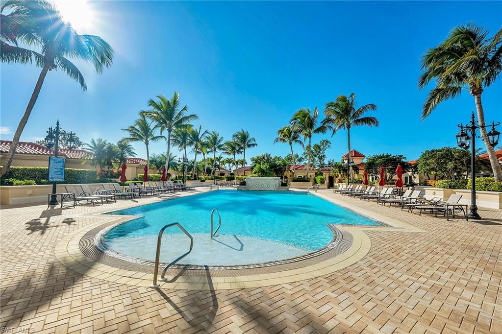 6597 Nicholas Boulevard, Unit 1002 Naples, FL 34108 - Photo 34 of 41 a swimming pool with outdoor seating and yard