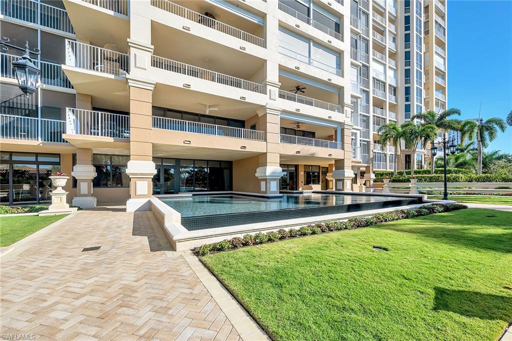 6597 Nicholas Boulevard, Unit 1002 Naples, FL 34108 - Photo 35 of 41 a front view of building with yard