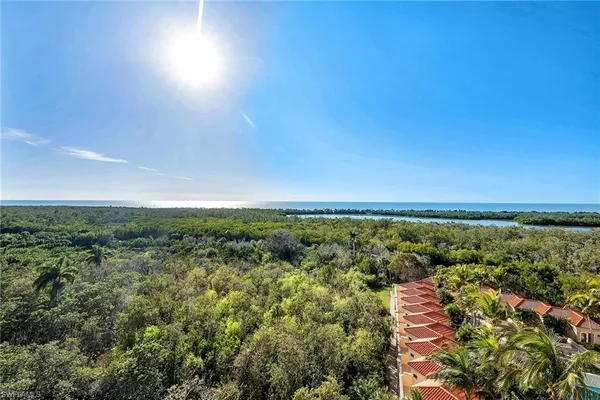an aerial view of residential houses with outdoor space and trees