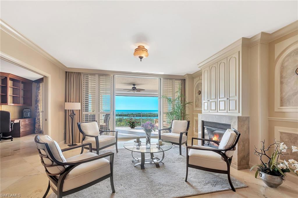 6597 Nicholas Boulevard, Unit 1002 Naples, FL 34108 - Photo 9 of 41 a living room with furniture and a large window