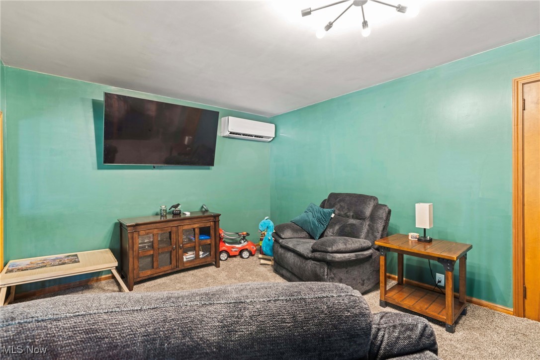 4270 Mellinger Road Canfield, OH 44406 - Photo 17 of 49 Carpeted family room featuring a chandelier