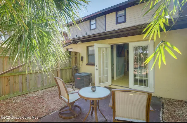 a view of an outdoor sitting area in a backyard