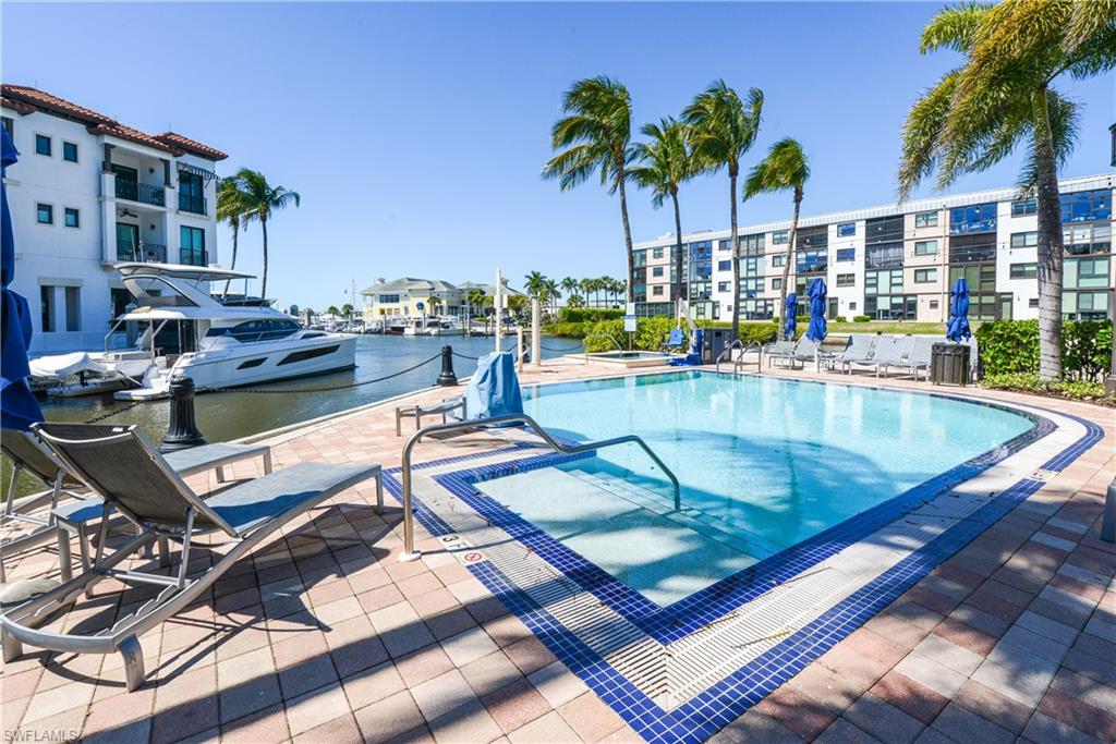1490 5th Avenue South, Unit 200B Naples, FL 34102 - Photo 5 of 43 View of private pool with a patio area, hot tub, with Marina and Naples Bay views