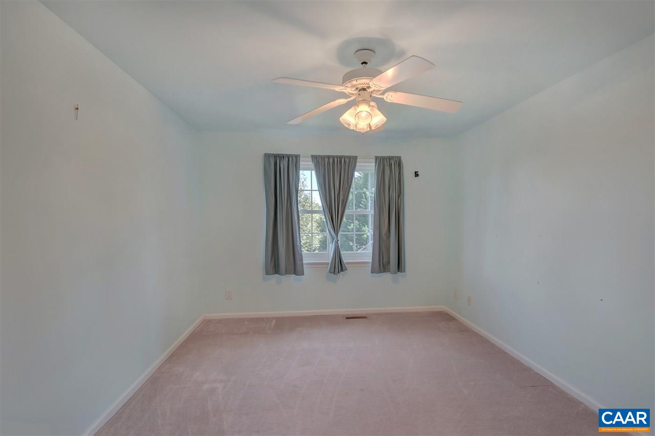 4753 Clover Ridge Court Charlottesville, VA 22901 - Photo 17 of 24 an empty room with a chandelier fan and windows