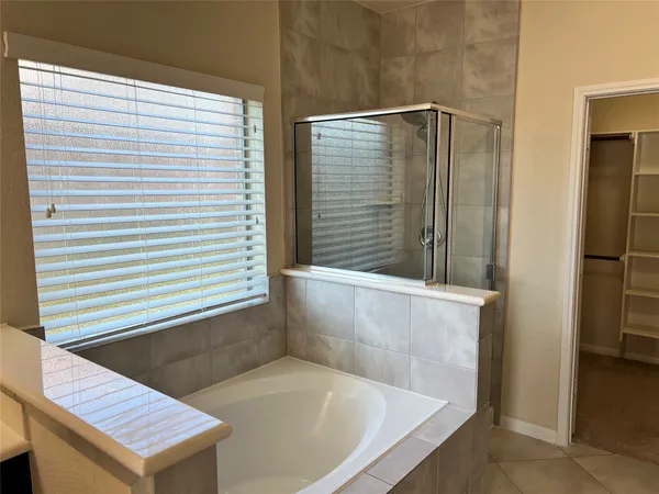 a bathroom with a bathtub and shower