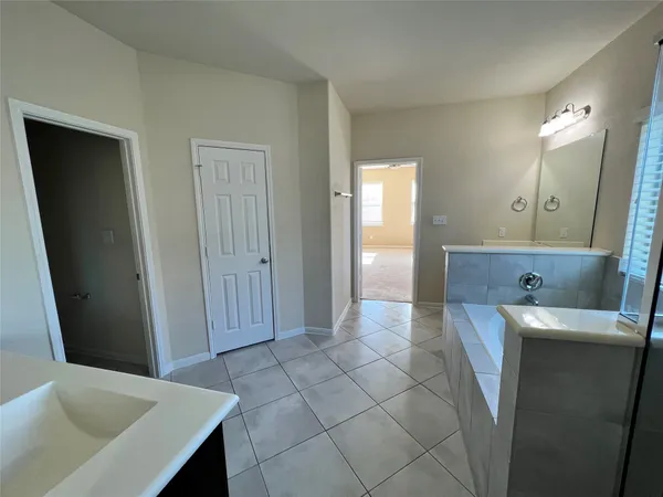 a view of hallway with bathroom and mirror