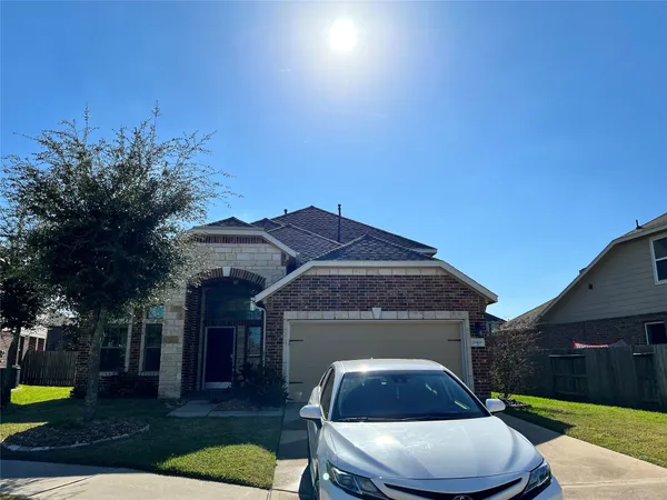 a front view of house with yard seating and green space