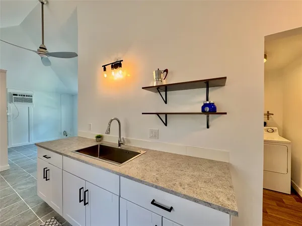 a kitchen with a sink and a refrigerator