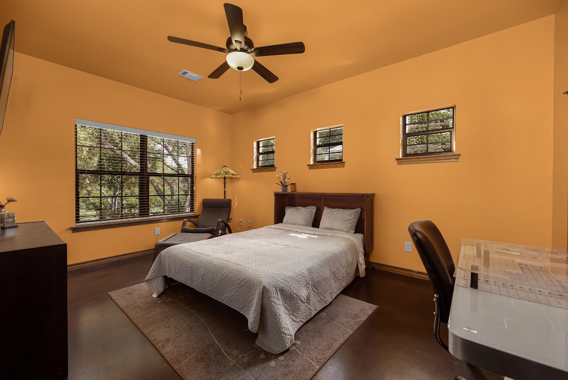 1546 Cox Road Blanco, TX 78606 - Photo 13 of 40 a bedroom with a bed chair and window