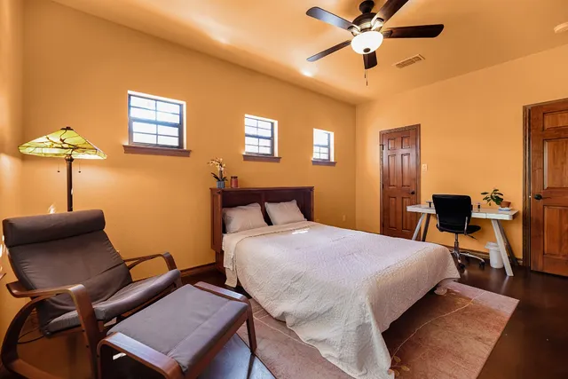 a bathroom with a granite countertop sink and a large mirror